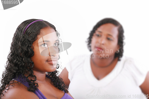 Image of teenage girl with unhappy mother in the background