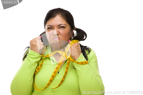 Image of Frustrated Hispanic Woman Tied Up With Tape Measure