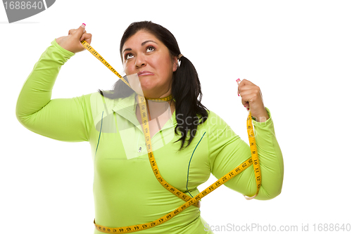 Image of Frustrated Hispanic Woman Tied Up With Tape Measure