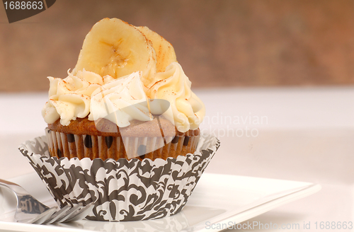 Image of Delicious carrot cake cupcake with cream cheese frosting, sliced