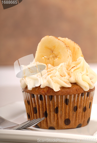 Image of Delicious carrot cake cupcake with cream cheese frosting, sliced