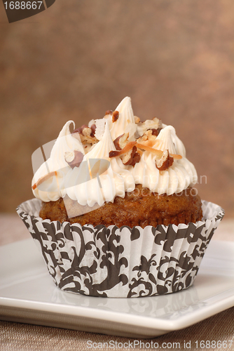 Image of Delicious carrot cake cupcake with cream cheese frosting and nut