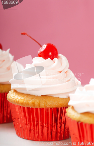 Image of Vanilla cupcake with maraschino frosting and cherry