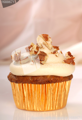 Image of Delicious carrot cake cupcake with cream cheese frosting and nut