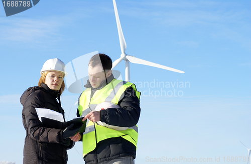 Image of team of  engineers or architects with white safety hat and wind 