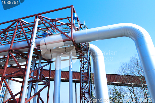 Image of Industrial zone, Steel pipelines and valves against blue sky