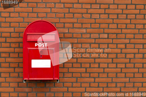 Image of red mailbox on stone wall
