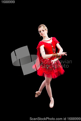 Image of ballerina wearing red tutu posing on isolated black