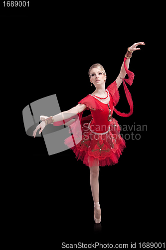 Image of ballerina wearing red tutu posing on isolated black
