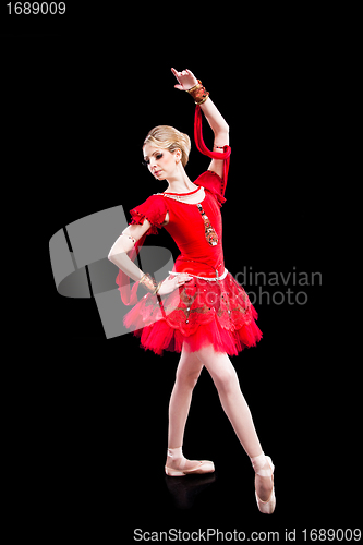 Image of ballerina wearing red tutu posing on isolated black