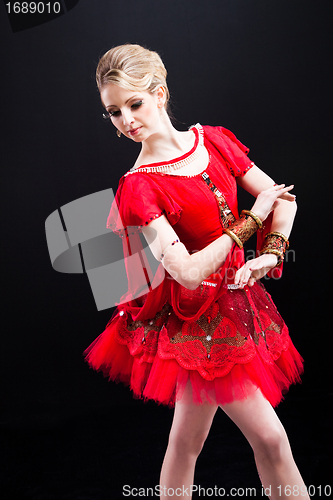 Image of ballerina wearing red tutu posing on isolated black