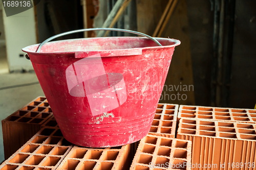 Image of Bucket on hollow bricks