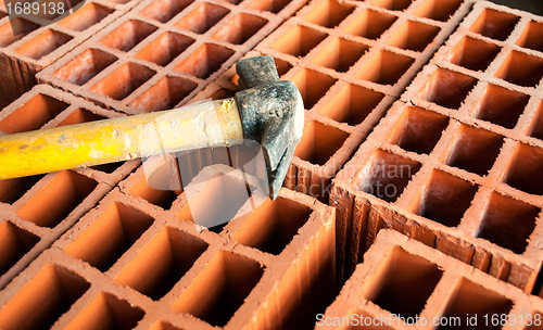 Image of Hollow brick with hammer