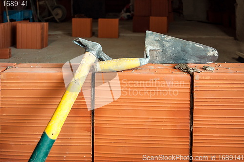Image of Hammer and trowel on construction site