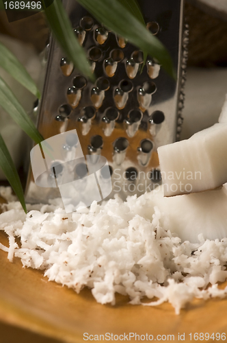 Image of Grated coconut with grater and nut 