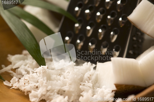 Image of Grated coconut with grater and nut 