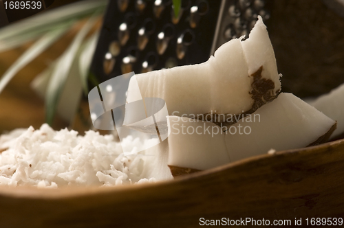 Image of Grated coconut with grater and nut 