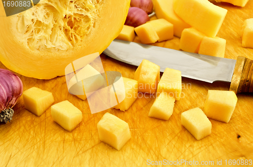 Image of Zucchini yellow on the board with garlic and knife