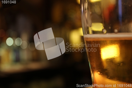 Image of blurry beer mug in a bar