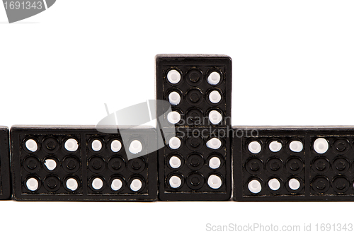 Image of Sequence of black domino parts isolated on white 