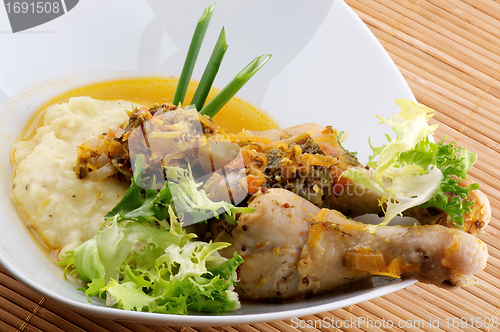 Image of Roasted chicken legs with mashed potatoes, vegetables saute and greens