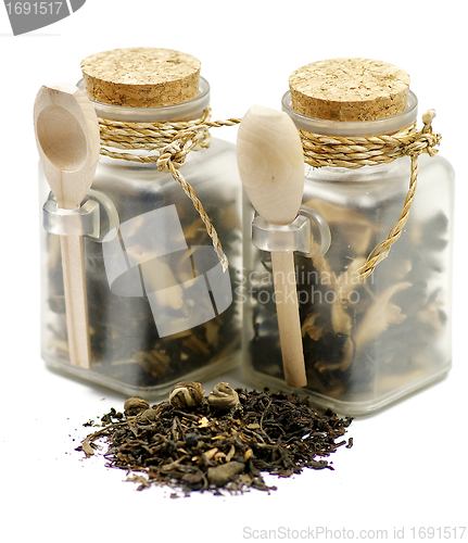 Image of Tea leaves in transparent parisons with wooden spoon