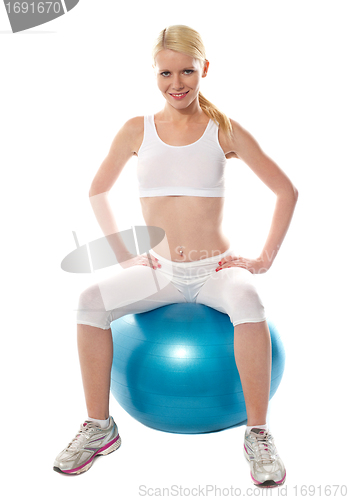 Image of Gorgeous teenager sitting on exercise ball