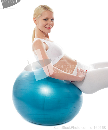 Image of Beautiful teenage girl back stretch over exercise ball
