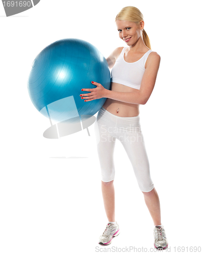 Image of Healthy fit female athlete with a ball