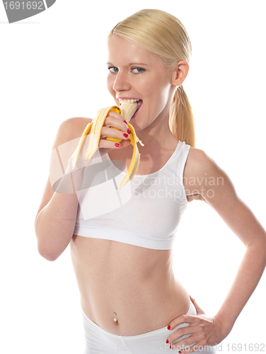 Image of Wanna some? A starving sexy woman eating banana