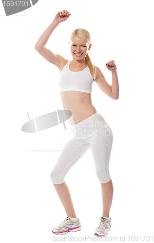 Image of Cheerful sporty fit girl in sporty outfit