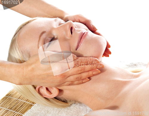Image of Gorgeous young woman relaxing in a spa salon