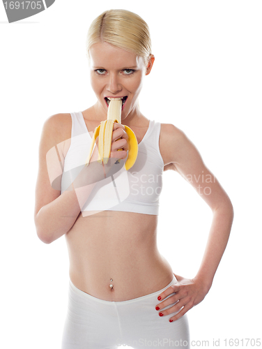 Image of Starving sexy woman eating banana