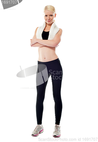 Image of Smiling sports woman standing with folded arms