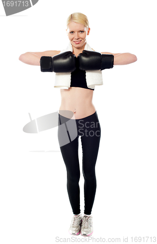 Image of Happy female boxer posing with gloves on