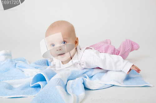 Image of little girl on a blue towel