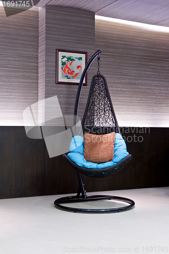 Image of chair hanging on a chain in the hotel lobby