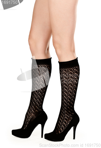 Image of female legs in fishnet socks and shoes