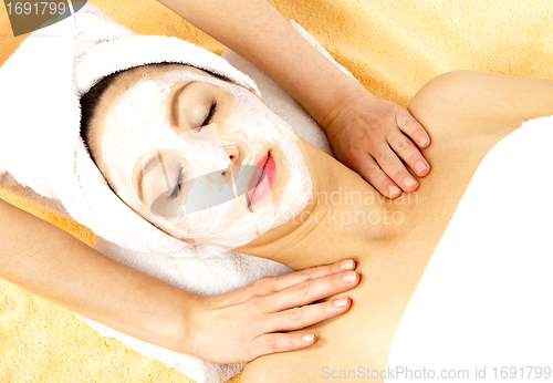 Image of young beautiful brunette woman doing wellness with massage