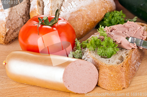 Image of breakfast or lunch with mixed vegetables, sausage and a knife