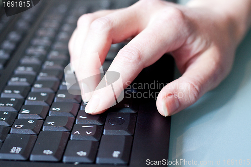 Image of womans hand on a coumputer keyboard