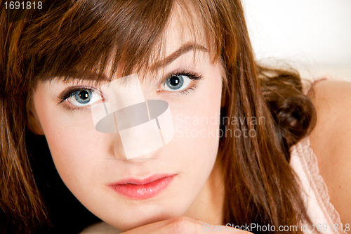 Image of portrait of a beautiful young brunette girl with a bright smile