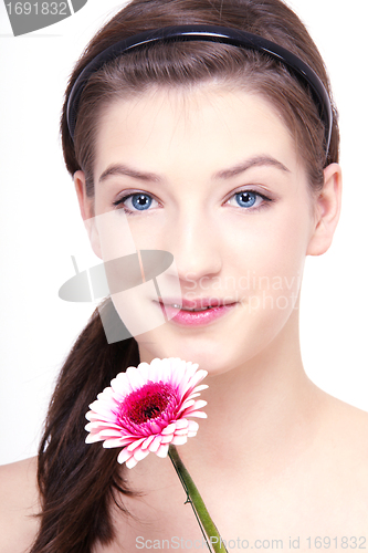 Image of young beautiful brunette woman with flower