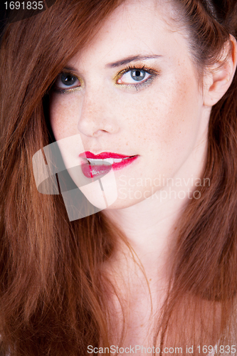 Image of portrait of a beautiful young woman with red hair and red lips