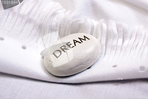Image of white dream stone on a white blanket 