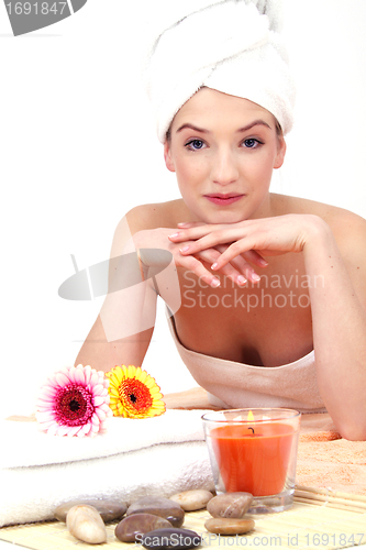 Image of young beautiful woman with a towel doing wellness