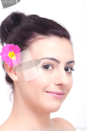 Image of young beautiful brunette woman with flower