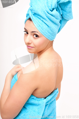 Image of young beautiful woman with a towel doing wellness