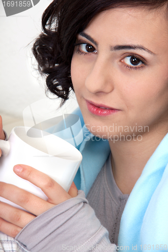 Image of young beautiful girl with a cup of coffee