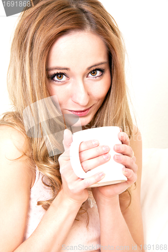 Image of young beautiful girl with a cup of coffee